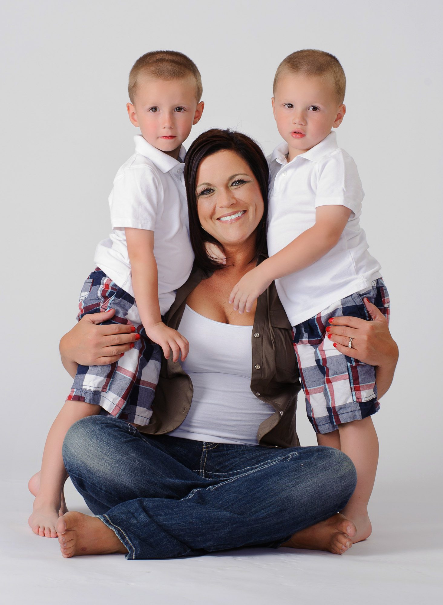 studio portrait of mother with toddlers